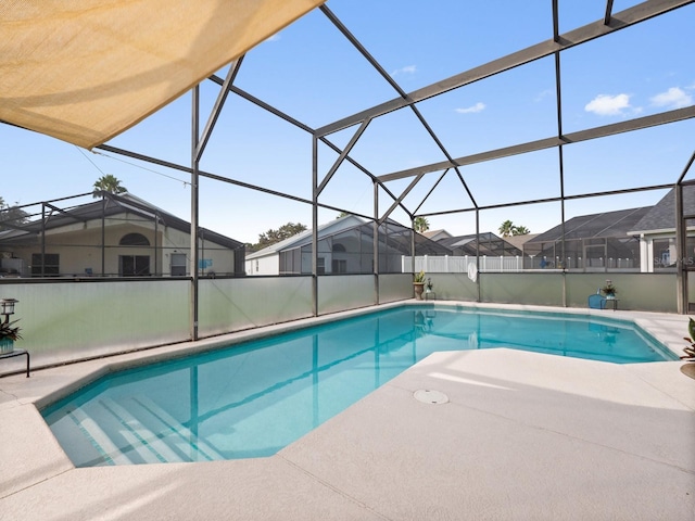 view of swimming pool with a patio and a lanai