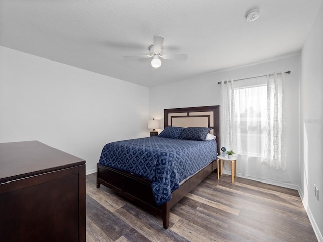 bedroom featuring ceiling fan and dark wood-type flooring