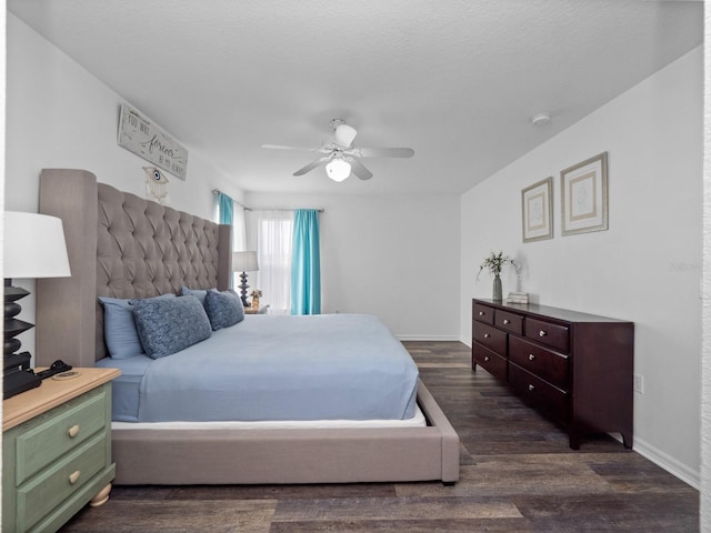 bedroom featuring a textured ceiling, dark hardwood / wood-style floors, and ceiling fan