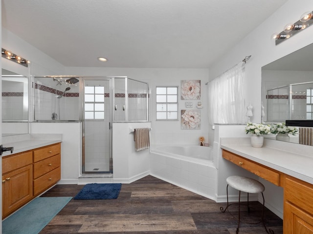 bathroom with vanity, hardwood / wood-style flooring, and independent shower and bath