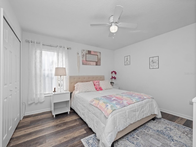 bedroom with ceiling fan, dark hardwood / wood-style floors, and a closet