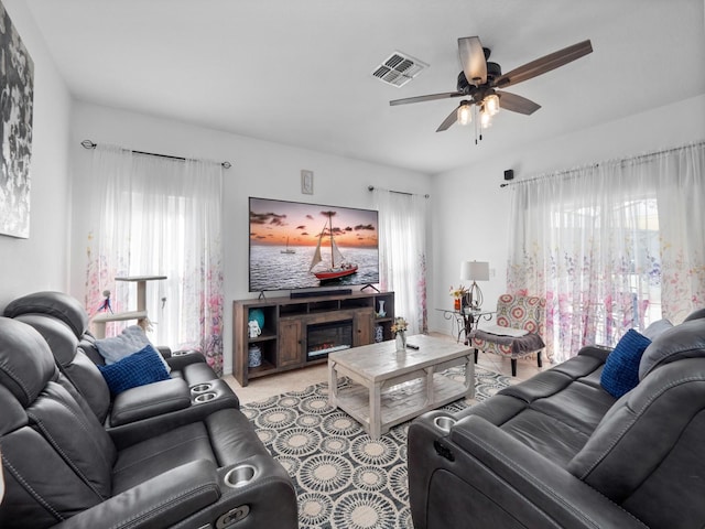 living room with light colored carpet and ceiling fan