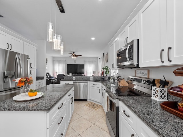 kitchen with ceiling fan, light tile patterned floors, dark stone counters, white cabinets, and appliances with stainless steel finishes