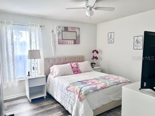 bedroom featuring ceiling fan and dark wood-type flooring