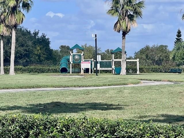 view of playground with a lawn