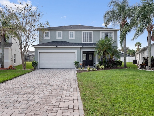 view of front of home with a front yard and a garage