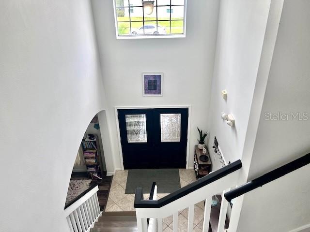 entrance foyer featuring tile patterned flooring and a high ceiling