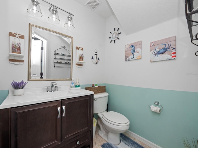 bathroom with tile patterned flooring, vanity, and toilet