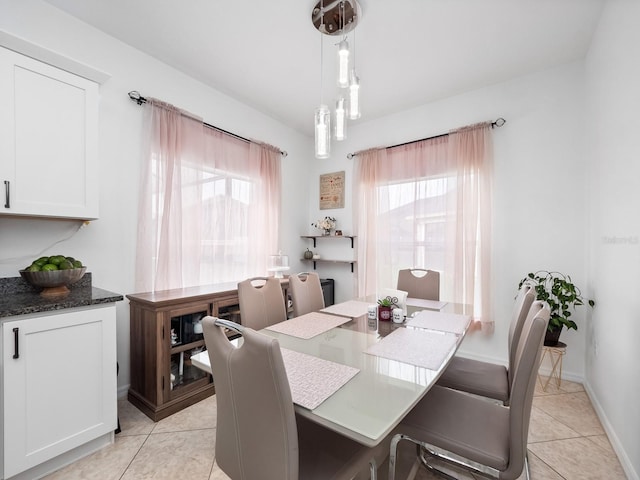 dining room featuring light tile patterned floors and an inviting chandelier