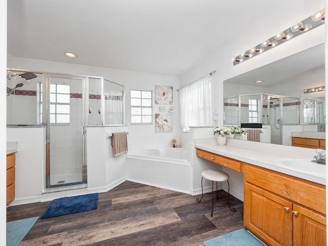 bathroom featuring plus walk in shower, wood-type flooring, and vanity