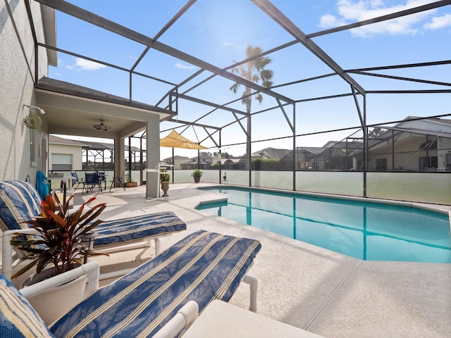 view of pool with a lanai, a water view, and a patio