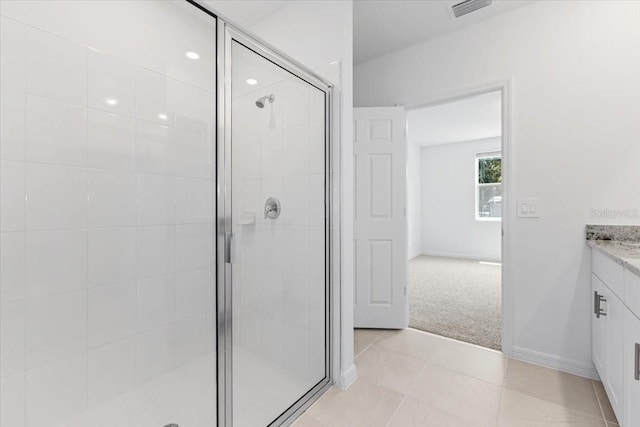 bathroom with tile patterned flooring, vanity, and an enclosed shower