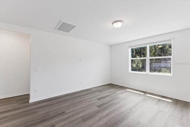 empty room featuring wood-type flooring