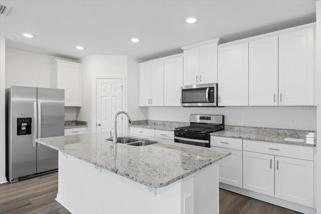 kitchen with a kitchen island with sink, sink, white cabinets, and stainless steel appliances