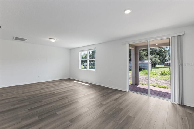 unfurnished room featuring dark hardwood / wood-style flooring