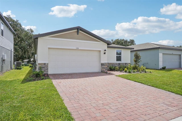 ranch-style house featuring a garage, central AC unit, and a front yard