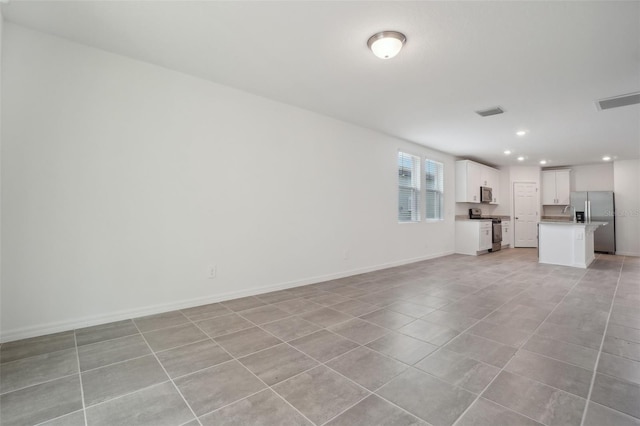 unfurnished living room featuring light tile patterned flooring