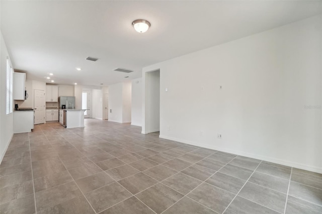 unfurnished living room featuring light tile patterned floors