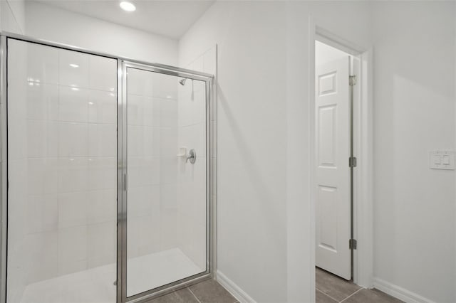 bathroom with tile patterned floors and a shower with shower door