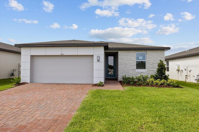 view of front of property featuring a front lawn and a garage