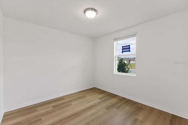 empty room with light hardwood / wood-style flooring