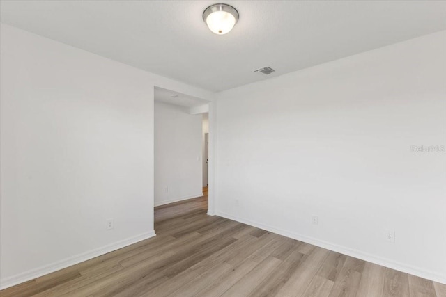 empty room with light hardwood / wood-style flooring