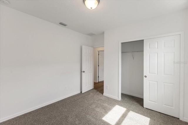 unfurnished bedroom with a closet and carpet floors