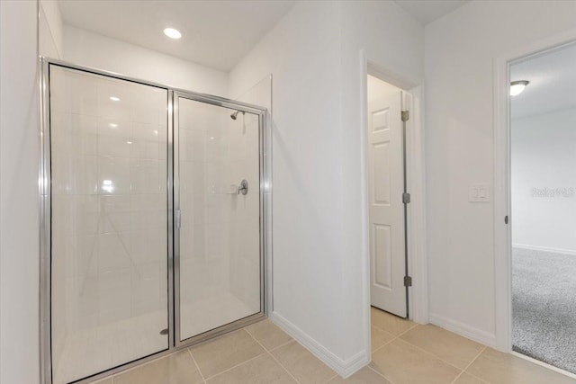 bathroom featuring tile patterned flooring and an enclosed shower