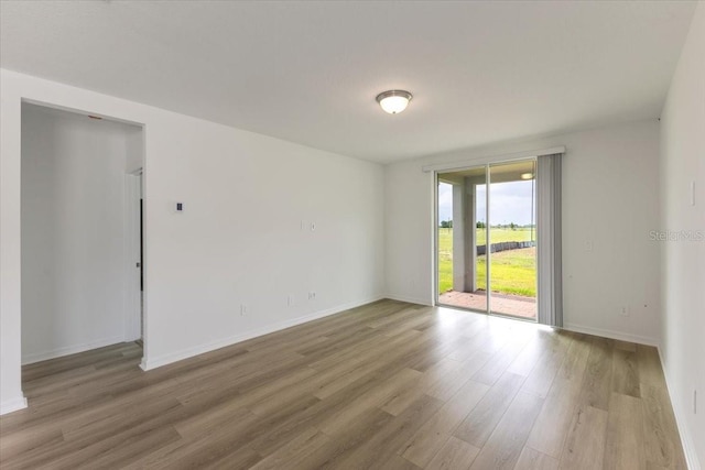 spare room with hardwood / wood-style flooring