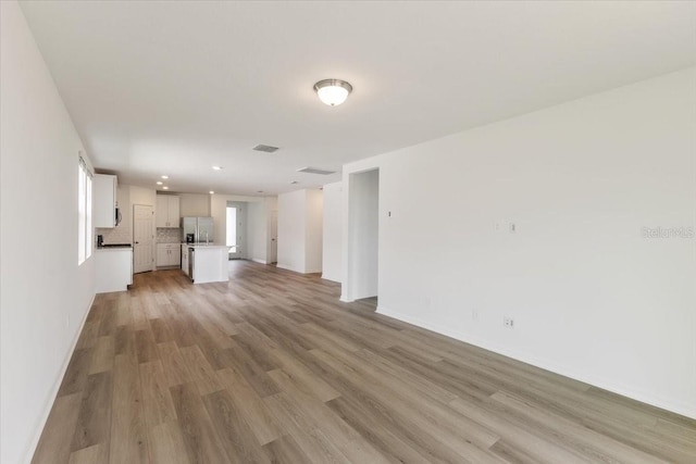 unfurnished living room featuring light wood-type flooring