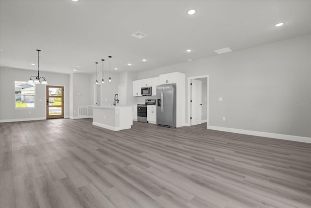 unfurnished living room with sink and light wood-type flooring