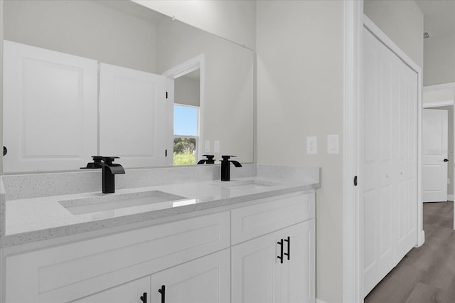 bathroom with vanity and hardwood / wood-style flooring