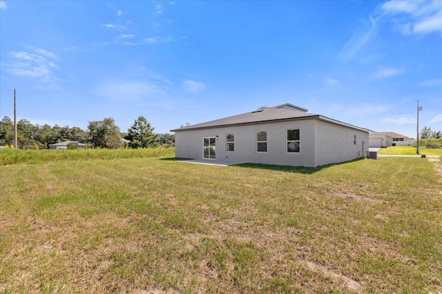 rear view of property featuring a yard