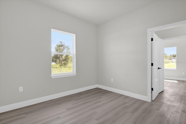 empty room featuring baseboards and wood finished floors
