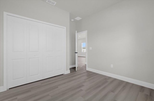 unfurnished bedroom featuring a closet and light hardwood / wood-style flooring