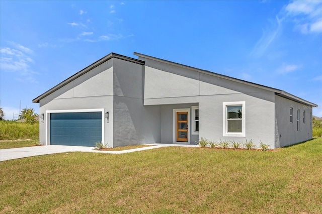 contemporary house featuring a front yard and a garage