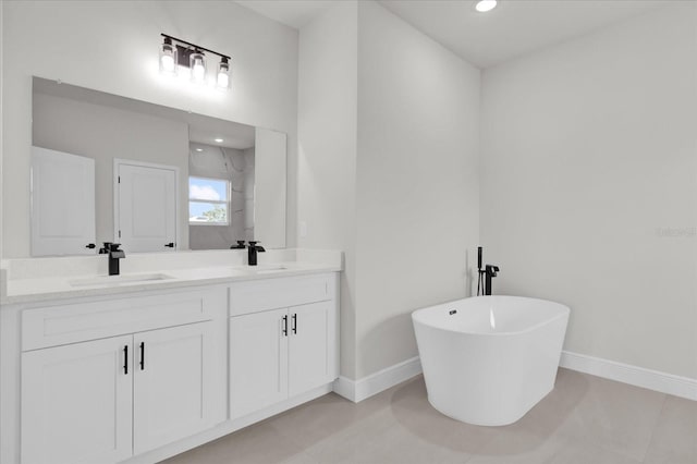 4683 SW 136th St, Ocala, FL 34473 - bathroom with baseboards, double vanity, a freestanding tub, and recessed lighting