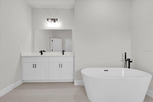 4683 SW 136th St, Ocala, FL 34473 - bathroom with double vanity, baseboards, and a freestanding bath