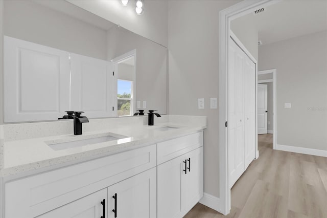4683 SW 136th St, Ocala, FL 34473 - full bathroom featuring baseboards, wood finished floors, and double vanity