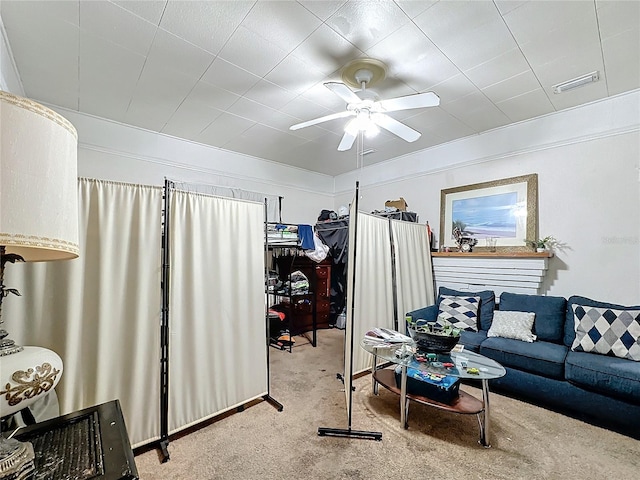 carpeted living room with ceiling fan