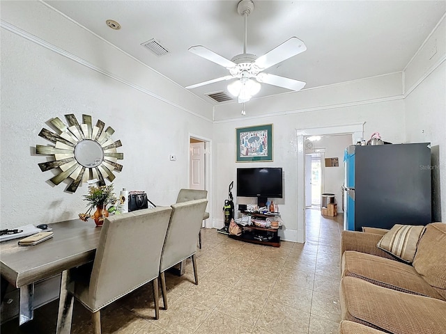 dining area featuring ceiling fan, light tile patterned flooring, and crown molding