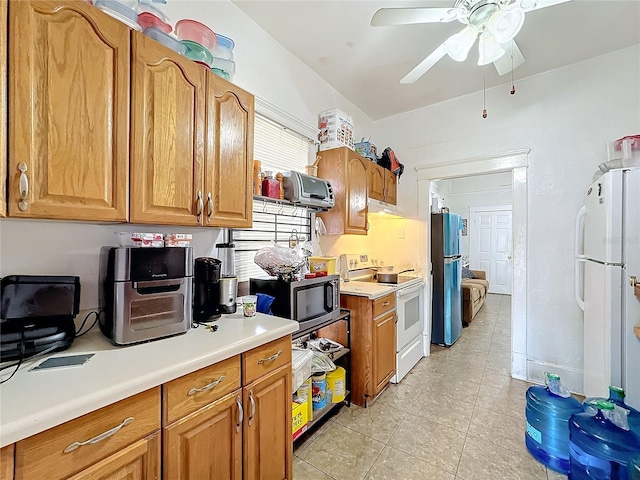 kitchen featuring light tile patterned floors, stainless steel appliances, and ceiling fan