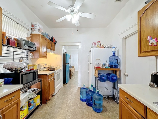 kitchen featuring ceiling fan, light tile patterned flooring, and stainless steel appliances