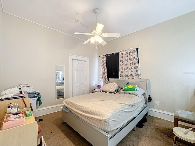 bedroom with ceiling fan, carpet floors, and a closet