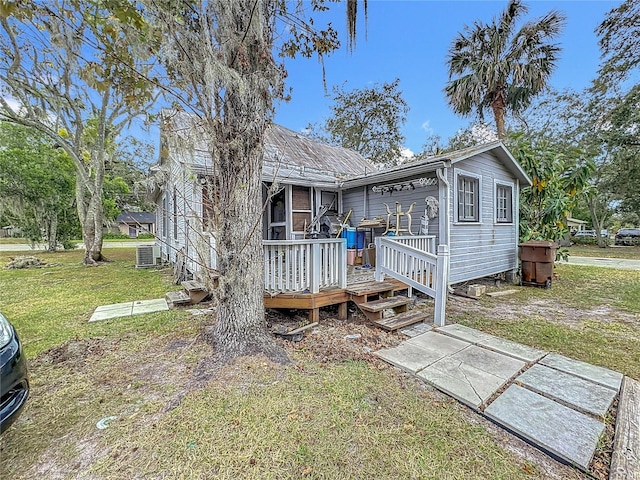 back of house with a yard, central AC unit, and a deck