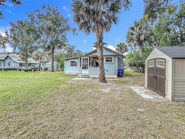 view of front of property with a front lawn and a storage shed