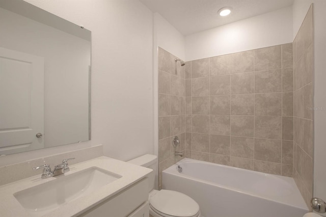 full bathroom with tiled shower / bath combo, vanity, and toilet