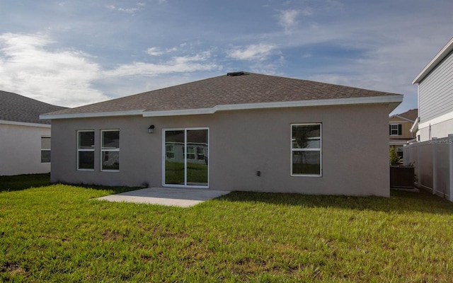 rear view of house with a lawn and a patio area