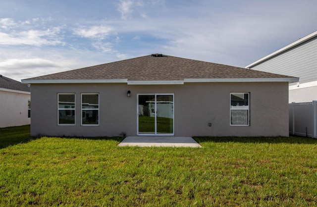 rear view of property with a yard