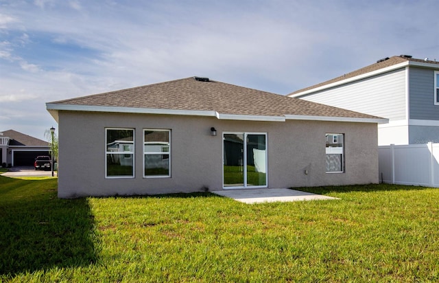 rear view of house featuring a lawn and a patio